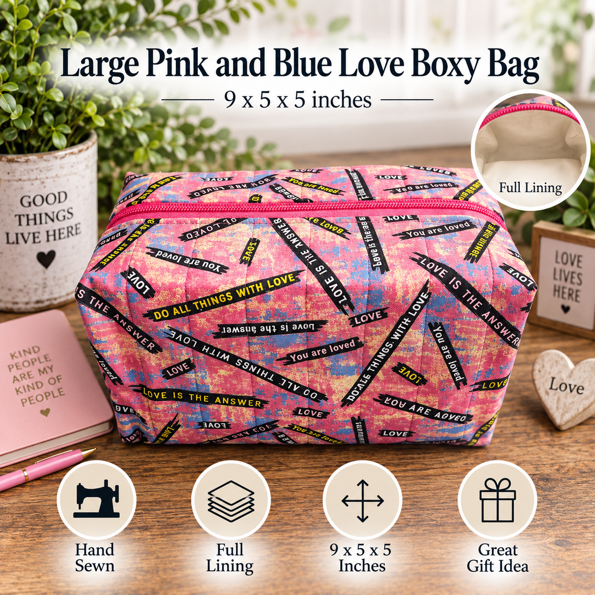 A large pink and blue fabric gift box bag with a black and yellow 'Love' pattern, displayed on a wooden table with decorative props. The image includes text overlays describing the bag's size (9 x 5 x 5 inches) and features, along with icons for 'Hand Sewn', 'Full Lining', '9 x 5 x 5 Inches', and 'Great Gift Idea'.