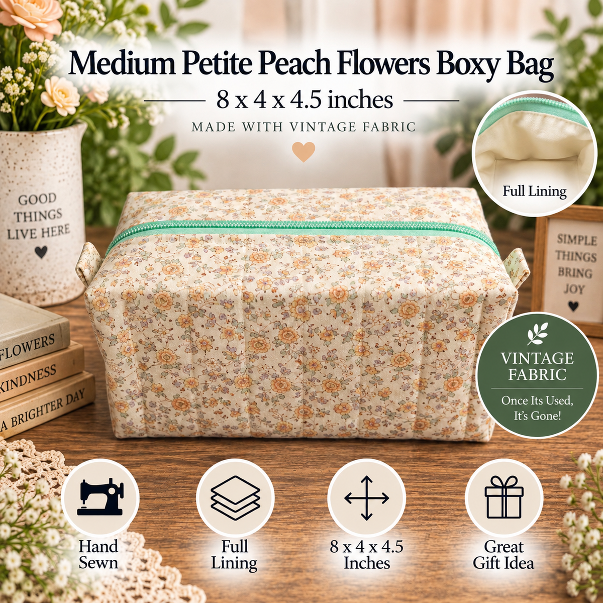 A floral fabric gift bag with a turquoise zipper, displayed on a wooden table with decorative flowers, books, and informational badges. The text at the top reads 'Medium Petite Peach Flowers Boxy Bag' with dimensions and 'Made with Vintage Fabric'.