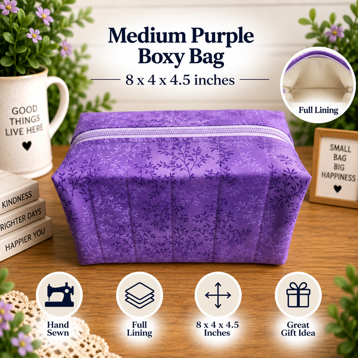A purple fabric boxy bag with a floral pattern sits on a wooden table, surrounded by decorative props including a mug, flowers, and a small sign. Text at the top reads 'Medium Purple Boxy Bag' with dimensions '8 x 4 x 4.