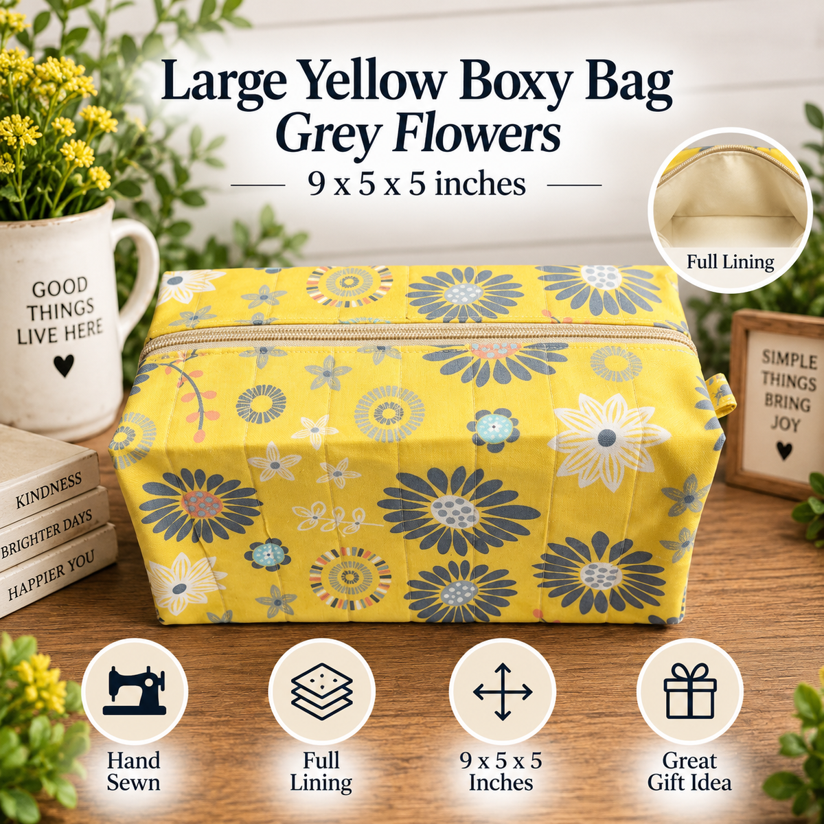A yellow fabric boxy bag with a grey and blue floral pattern, shown on a wooden table with decorative props including a mug, flowers, and text overlays describing its features.