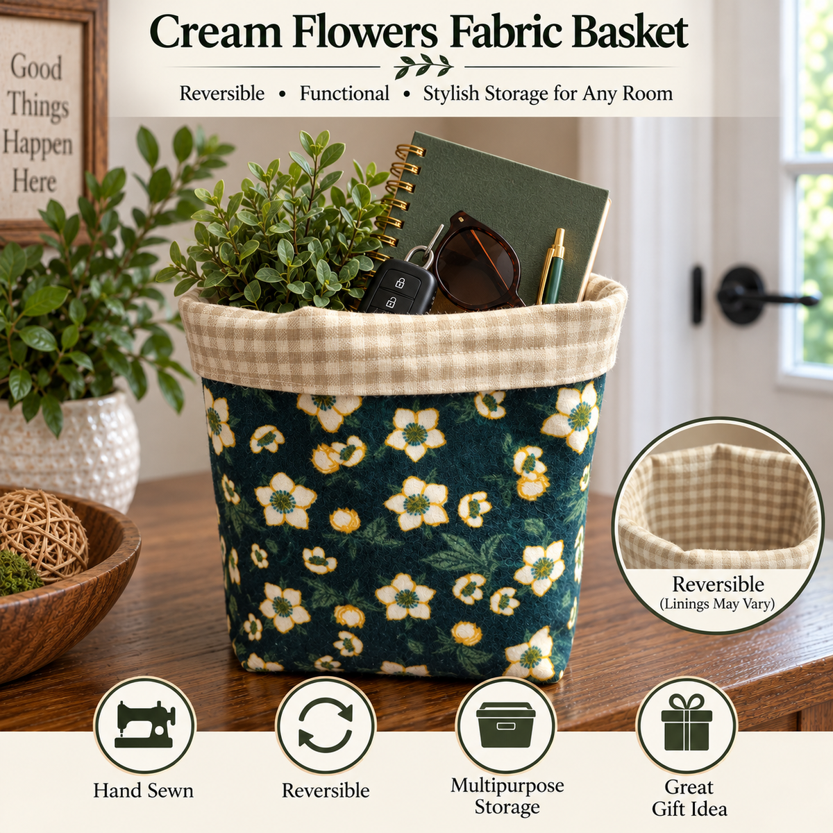 Cream flowers fabric storage basket shown on a wooden table in a home setting, filled with a notebook, sunglasses, and a small plant. The basket has a dark green floral pattern with cream and yellow flowers, and a cream gingham lining.