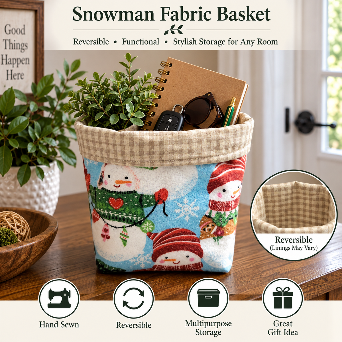 A snowman-themed fabric storage basket sits on a wooden table in a home setting, filled with a notebook, sunglasses, and a small plant. The basket features a white fabric body printed with colorful snowmen in red and green sweaters, a beige gingham top band, and a circular inset showing the reversible gingham lining.