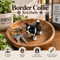 A 3D-printed black and white Border Collie dog keychain resting on a wooden dish, next to a set of keys. The image includes promotional text overlays reading 'Border Collie Keychain' and feature icons at the bottom.