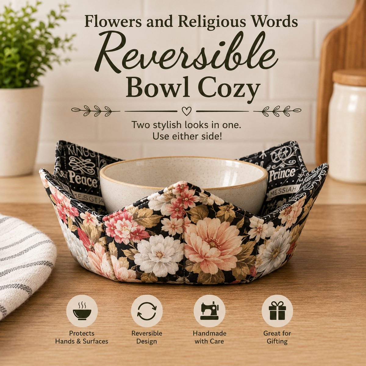 A floral reversible bowl cozy set on a wooden countertop, holding a ceramic bowl. The product features a black background with pink, peach, and white flowers, and the words 'Prince Peace' and 'Messiah' printed on the fabric.