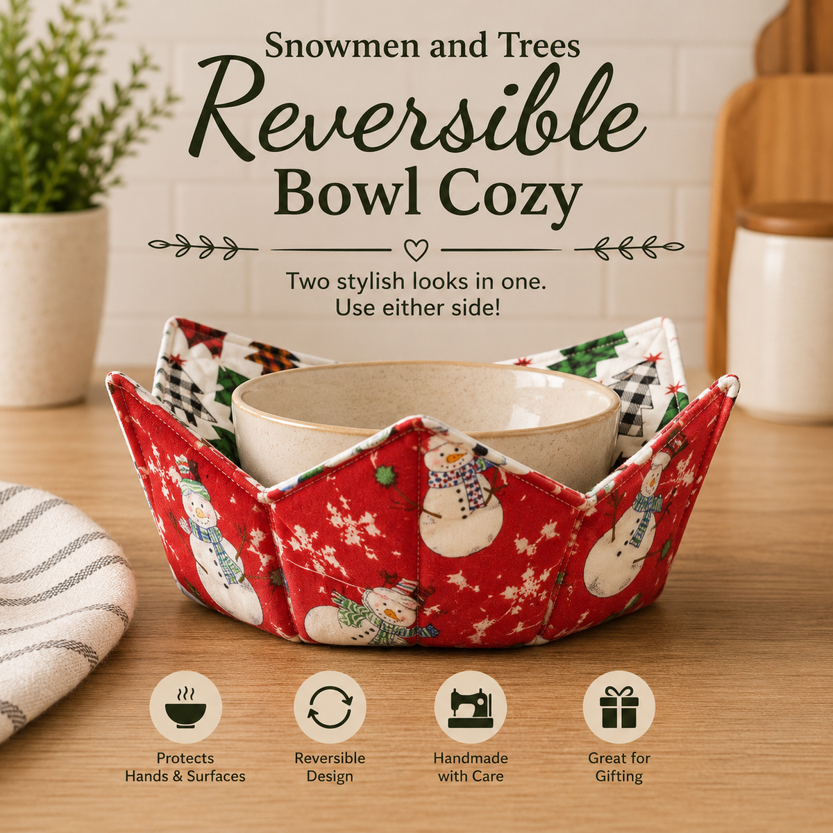 A red fabric bowl cozy with snowman prints holds a beige ceramic bowl on a wooden table. Text at the top reads 'Snowmen and Trees Reversible Bowl Cozy,' with feature icons along the bottom and a softly blurred kitchen background.