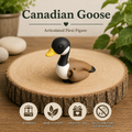 A small articulated Canadian goose flexi figure with a black and white head, yellow beak, and brown body, displayed on a round wood slice. The image includes text reading 'Canadian Goose Articulated Flexi Figure' and four feature icons at the bottom.