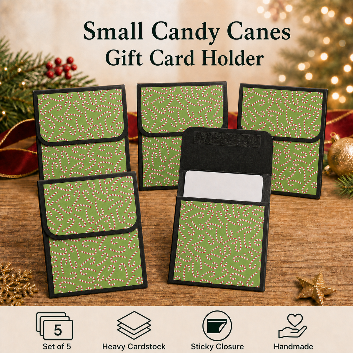 Five small candy canes gift card holders arranged on a wooden surface with holiday decorations in the background. The holders are olive green with a white speckled pattern and black borders, with one holder shown open to reveal a white card slot.