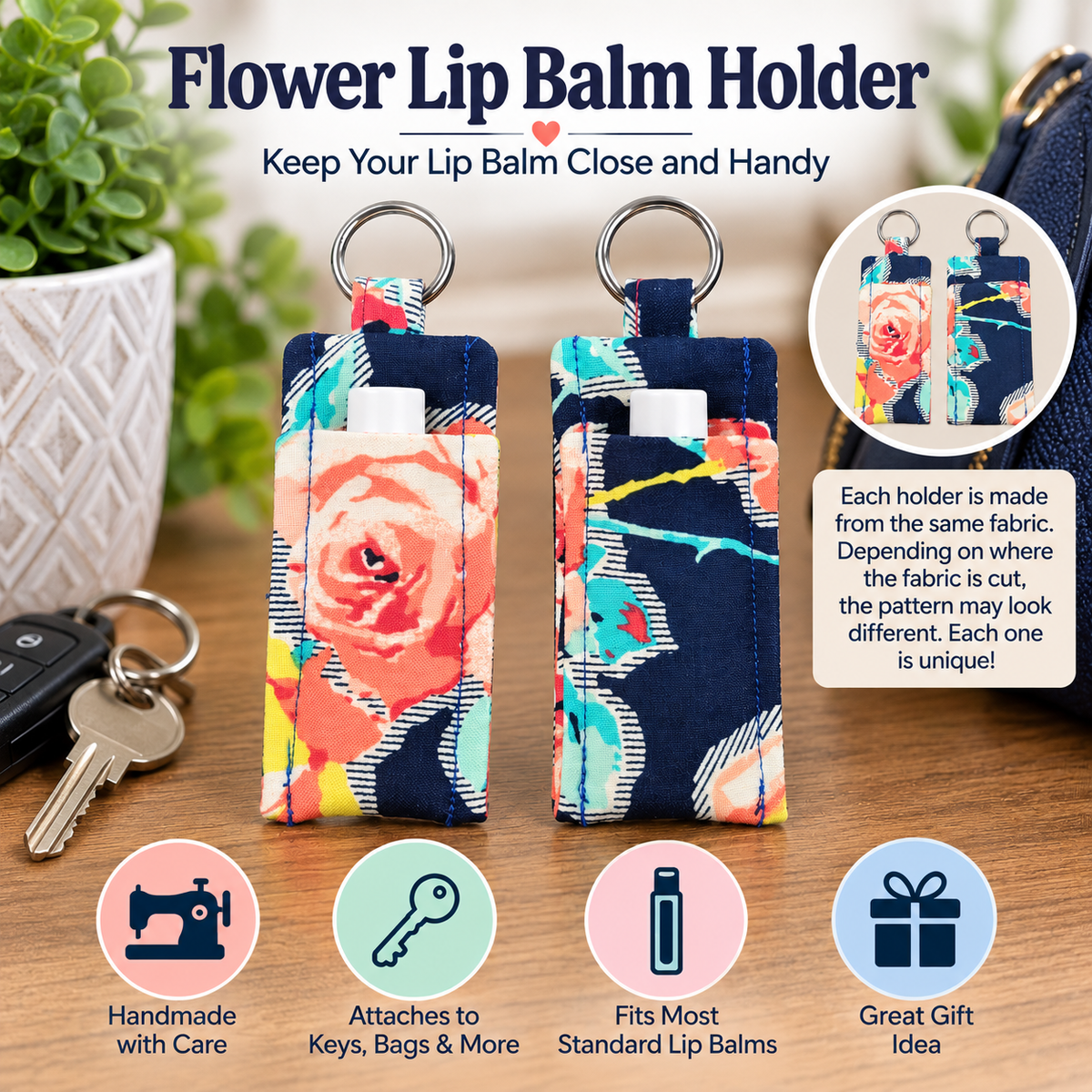 Two fabric flower lip balm holders with key rings, shown on a wooden surface with keys and a bag nearby. The holders feature a colorful floral print on a navy background.