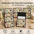 Five multicolor paw print gift card holders arranged on a tabletop with decorative ribbons and gift boxes. Large text at the top reads 'Multicolor Paw Print Gift Card Holders For All Occasions,' and small icons at the bottom mention a set of 5, heavy cardstock, sticky closure, and handmade quality.