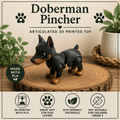 Doberman standing on a wood round on a table with some greenery 