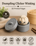 3D printed winking tan dumpling fidget toy nestled inside a matching grey steamer basket.