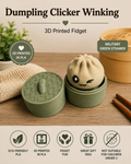 A 3D printed fidget toy shaped like a steaming dumpling in a green round container, shown open with the lid beside it on a tabletop. The image includes promotional text reading 'Dumpling Clicker Winking,' '3D Printed Fidget,' and 'Military Green Steamer,' plus small icons about PLA material and gift appeal.