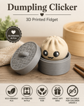 A 3D printed dumpling-shaped fidget toy sitting in a round gray container with its lid beside it on a wooden surface. The lid has a raised dumpling pattern.