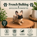 French Bulldog standing on a wood round with green plants behind it on a table
