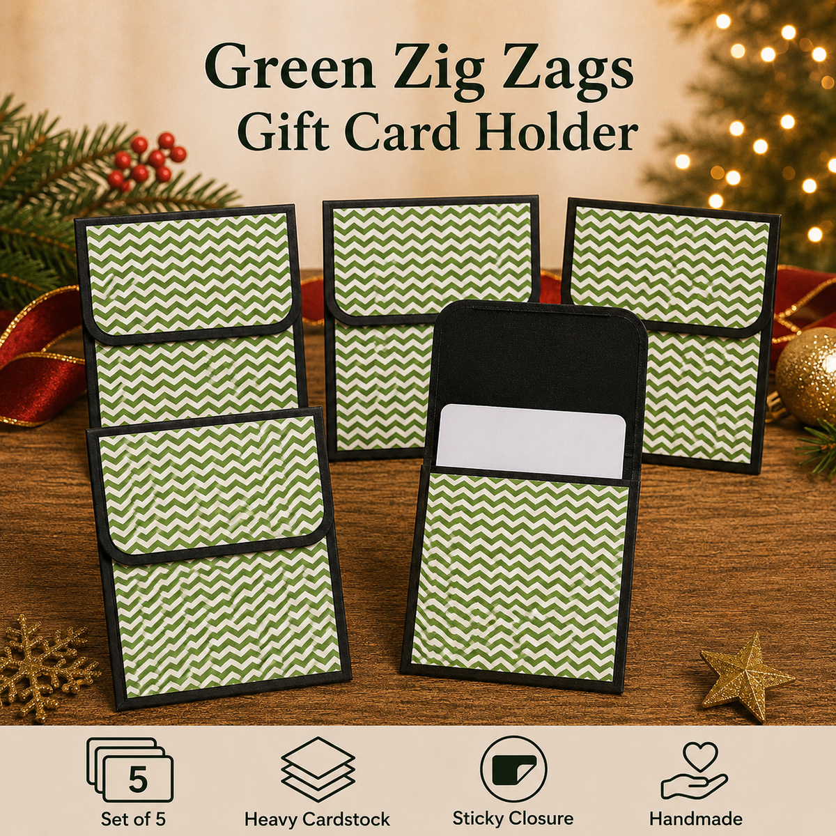Five green and white chevron-patterned gift card holders with black trim are arranged on a wooden surface with holiday decorations in the background. Text at the top reads 'Green Zig Zags Gift Card Holder,' and feature icons at the bottom mention a set of 5, heavy cardstock, sticky closure, and handmade quality.