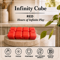 Red cube-shaped toy blocks labeled 'Infinity Cube' on a marble coaster, with text reading 'RED Hours of Infinite Play' and feature icons along the bottom.