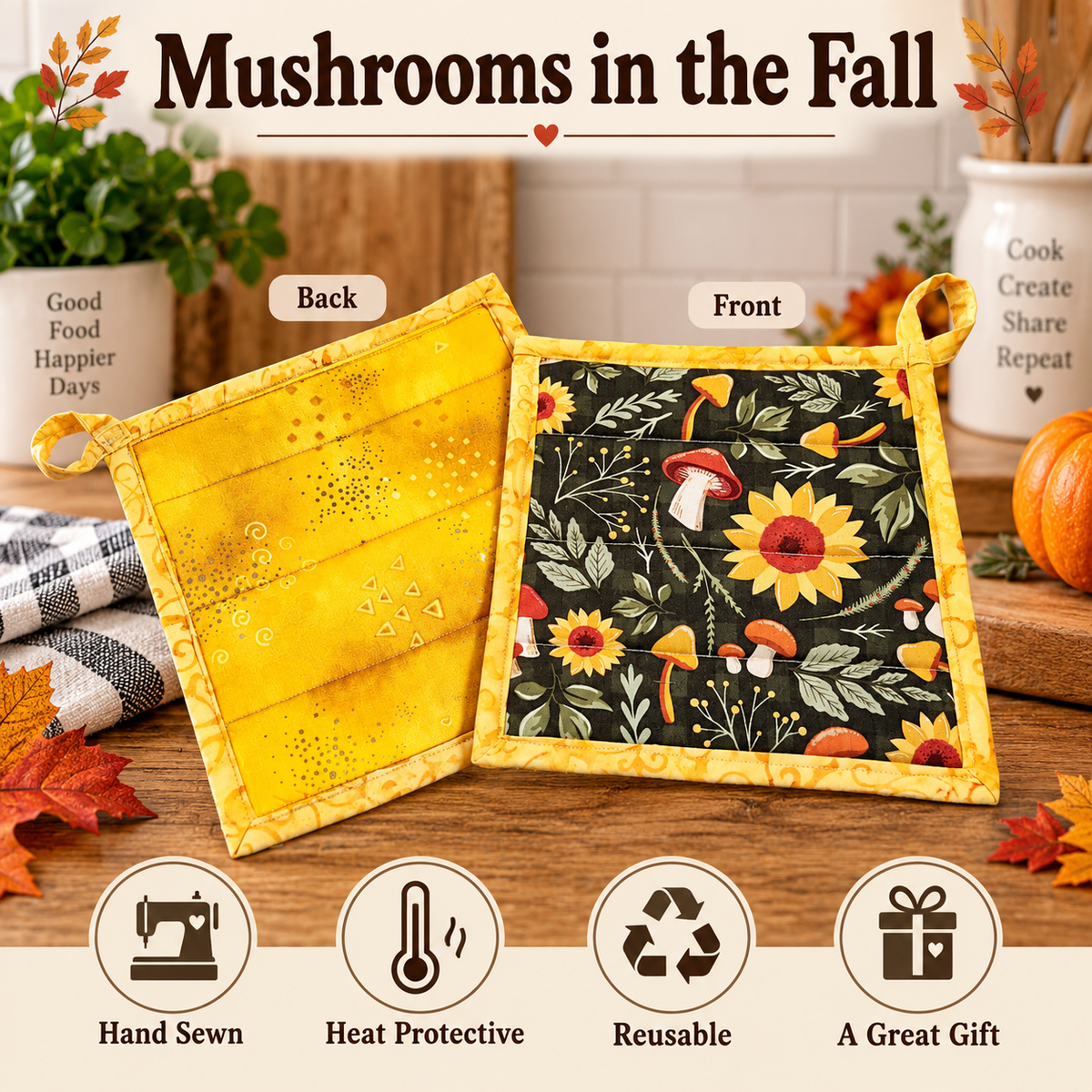 Two reusable potholders displayed on a wooden table with autumn-themed props. One side shows a yellow fabric back with small printed motifs, and the other shows a black front panel decorated with yellow sunflowers, red mushrooms, and green leaves, all with yellow borders.