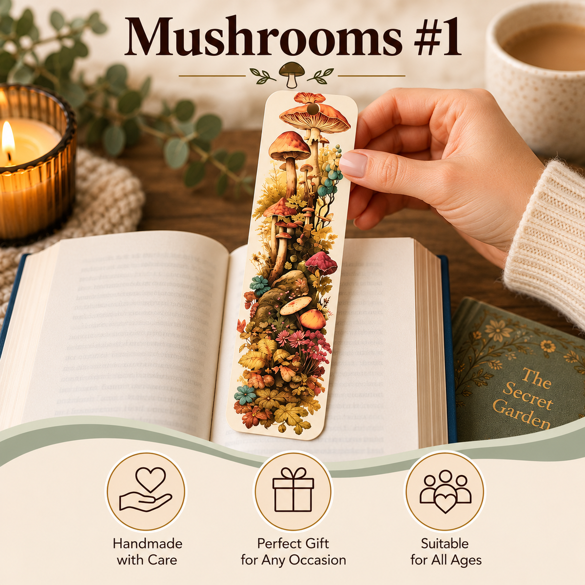 A hand holds a long rectangular bookmark featuring a colorful mushroom forest illustration over an open book. The scene includes a candle, eucalyptus leaves, a cup of coffee, and text reading “Mushrooms #1” with selling points about handmade care, gift suitability, and age versatility.