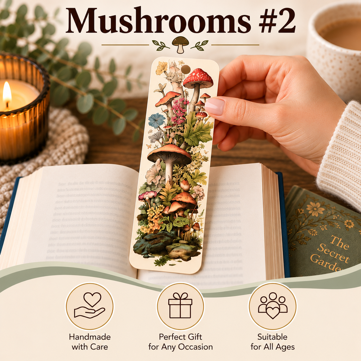 A hand holds a mushroom-themed bookmark over an open book, with a candle, mug of coffee, and another book in a cozy setting. The bookmark features an illustrated design of red, brown, and green mushrooms with flowers and leaves.