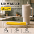 A yellow lid wrench tool displayed on a kitchen counter next to a beige HydroJug travel tumbler with a straw. The image includes text reading 'LID WRENCH', 'Made Specifically to Fit Your HydroJug', and 'YELLOW', plus feature icons for custom fit, easy grip, and printed with PLA.