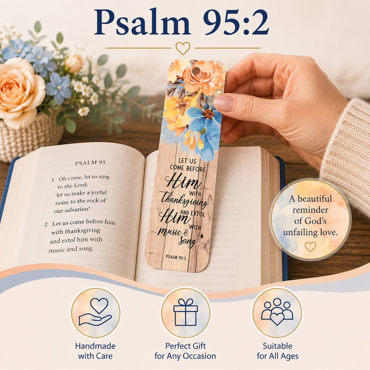 A hand holds a decorative Psalm 95:2 bookmark over an open book on a styled tabletop with flowers. The bookmark has a floral top and a wood-grain lower section with the text 'LET US COME BEFORE Him with thanksgiving and praise Him music & song PSALM 95:2'.