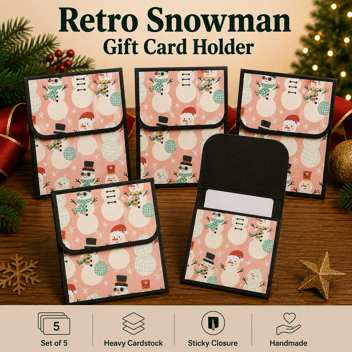 Five retro-themed snowman gift card holders arranged on a wooden surface with holiday decorations. The holders feature a pink background with a snowman pattern and black borders, with one holder shown open to display the interior card slot.