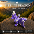 A purple and white articulated dragon toy posed on a large rock with a mountain landscape at sunset in the background. Large text reads 'SITTING DRAGON' with size details, and feature icons appear along the bottom.