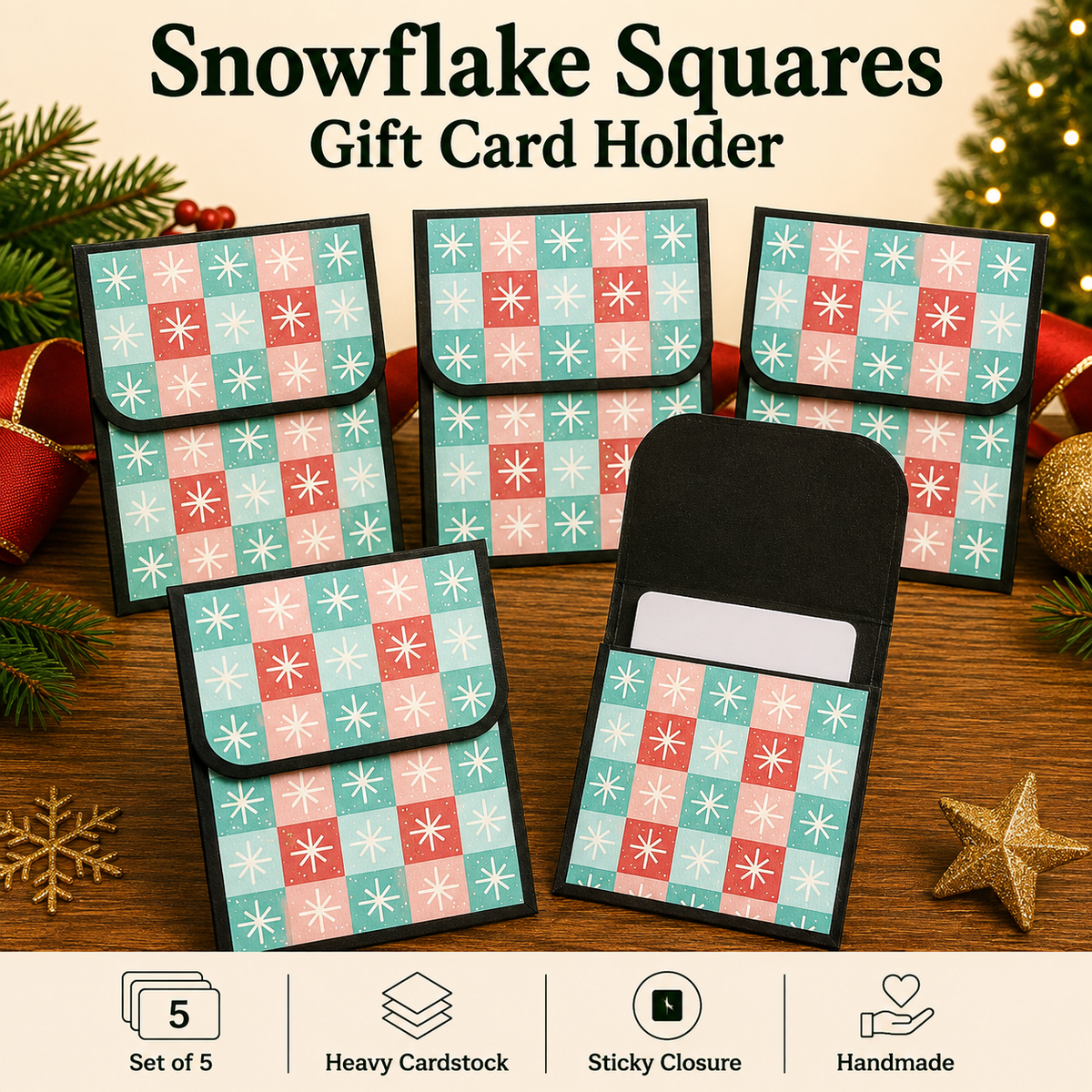 Five snowflake-patterned gift card holders arranged on a wooden surface with holiday decorations. The holders feature a black border and a grid of pastel pink, red, and light blue snowflakes.