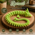 A green articulated dragon figurine displayed on a round wood slice coaster, with a small matching sprout piece beside it. The scene includes promotional text reading 'Sprout Articulated Dragon' and '12" LONG,' plus feature icons at the bottom.