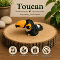Black white and orange 3D printed Toucan Flexi with articulated body, large orange beak and blue eye detail, printed by Twin Cedars Maker Company.
